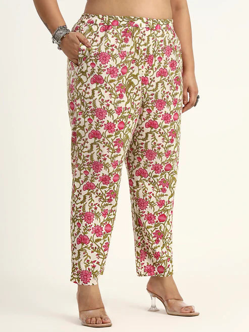 Floral patterned pants worn by a person on a plain background