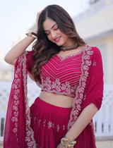 Woman in a red traditional outfit with intricate patterns outdoors.