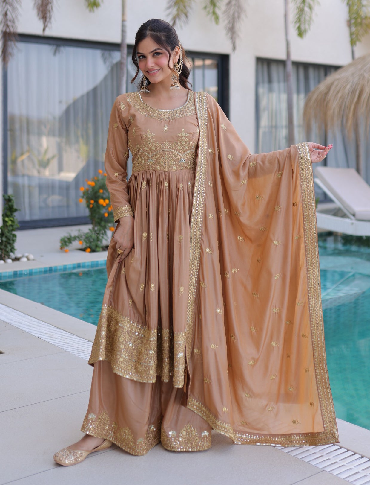 Woman in a traditional outfit by a poolside