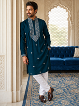 Dark teal embroidered kurta with white pyjamas, full-length front view