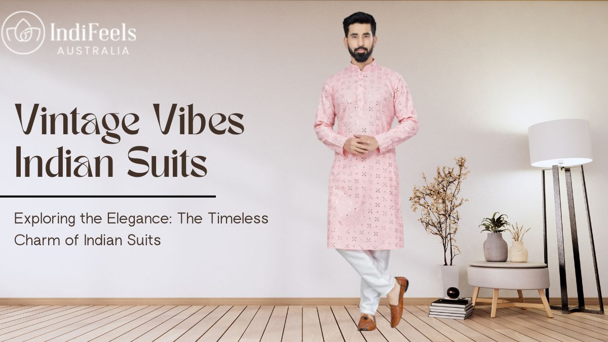 A man wearing a stylish light pink embroidered kurta and white pajama set, standing gracefully in a minimalistic room with wooden flooring and elegant decor.