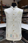White embroidered vest on a mannequin in a fabric store