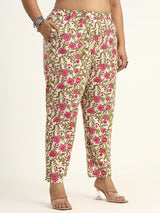 Floral patterned pants worn by a person on a plain background