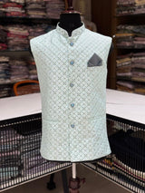 Light blue patterned vest on a mannequin in a store setting