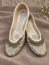 Ivory Punjabi jutti for women with silver embroidery and decorative embellishment