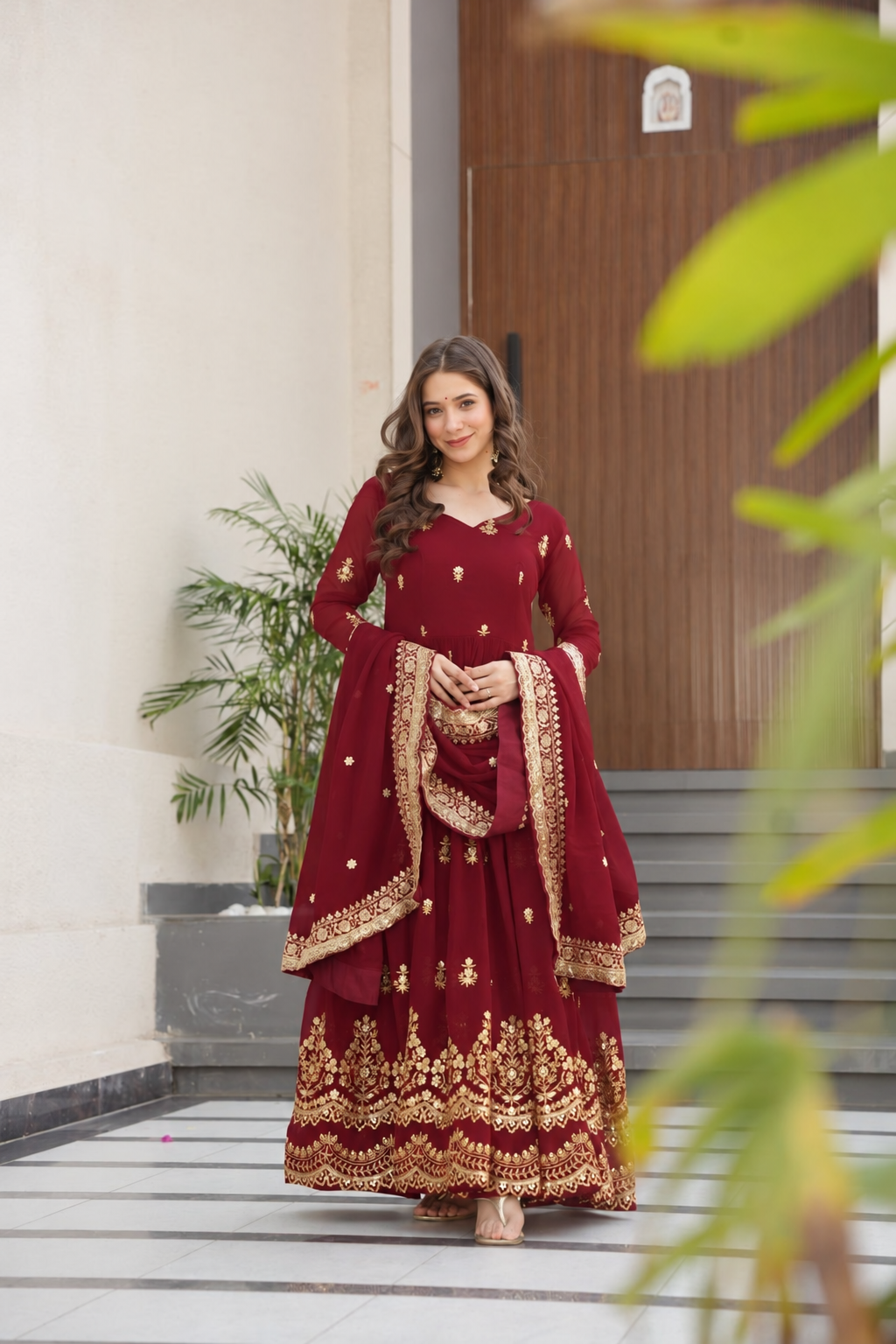 Maroon gown with gold embroidery and matching dupatta
