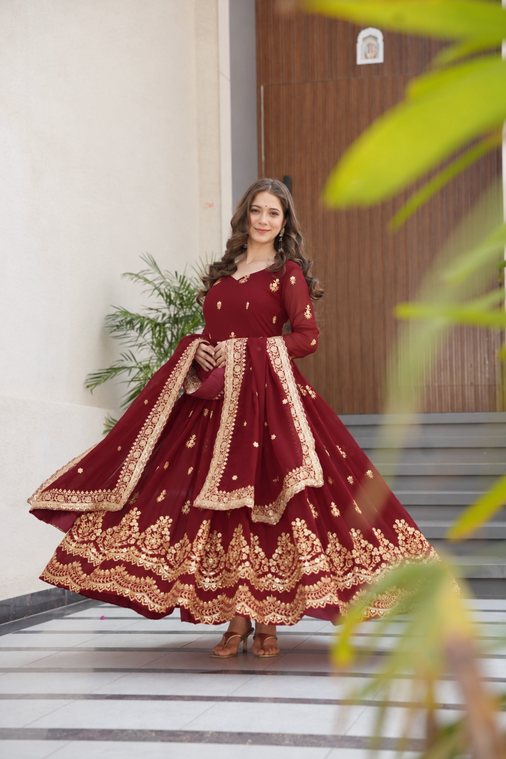 Maroon gown with gold embroidery and matching dupatta