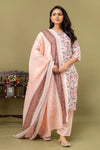 Woman wearing a traditional outfit with a pink dupatta on a green background