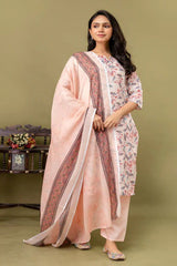 Woman wearing a traditional outfit with a pink dupatta on a green background