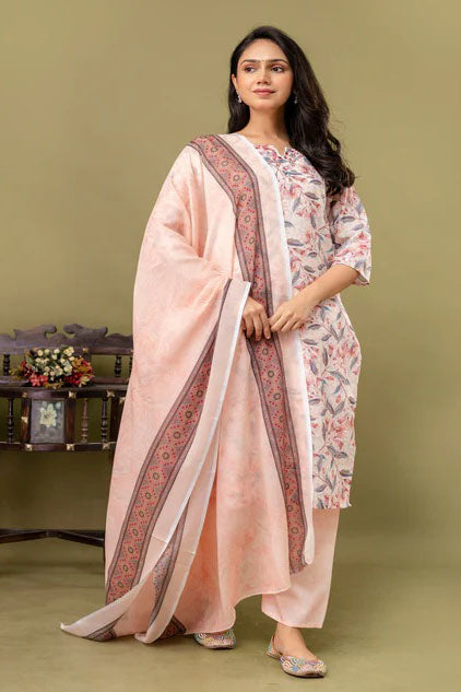 Woman wearing a traditional outfit with a pink dupatta on a green background